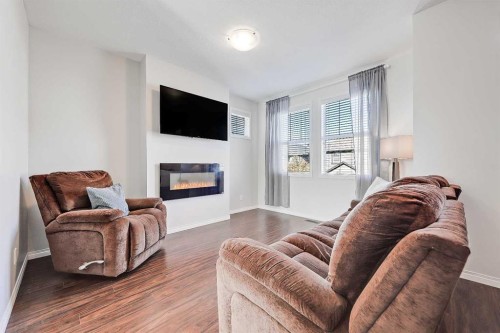 401-1086 Williamstown Boulevard Nw, Airdrie, AB - Indoor Photo Showing Living Room With Fireplace