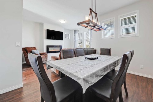 401-1086 Williamstown Boulevard Nw, Airdrie, AB - Indoor Photo Showing Dining Room With Fireplace