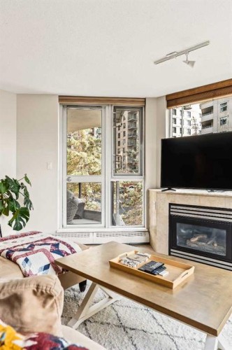 311-1108 6 Avenue Sw, Calgary, AB - Indoor Photo Showing Living Room With Fireplace