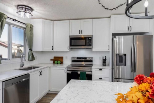 2348 Reunion Rise Nw, Airdrie, AB - Indoor Photo Showing Kitchen With Double Sink