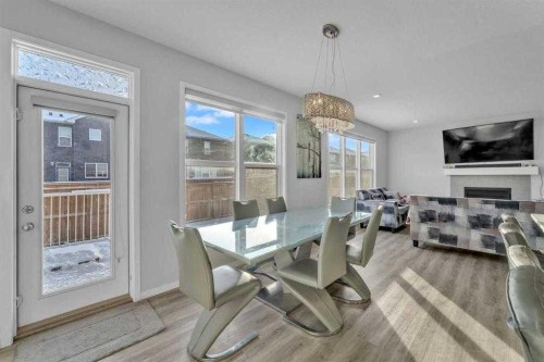 130 Red Sky Crescent Ne, Calgary, AB - Indoor Photo Showing Dining Room With Fireplace
