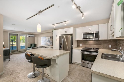 2101-10 Market Boulevard Se, Airdrie, AB - Indoor Photo Showing Kitchen With Double Sink With Upgraded Kitchen