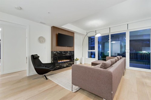 104-128 Waterfront Court Sw, Calgary, AB - Indoor Photo Showing Living Room With Fireplace