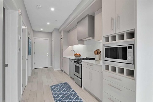 516-8230 Broadcast Avenue Sw, Calgary, AB - Indoor Photo Showing Kitchen With Upgraded Kitchen