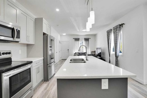 457 Canals Crossing Sw, Airdrie, AB - Indoor Photo Showing Kitchen With Stainless Steel Kitchen With Double Sink With Upgraded Kitchen