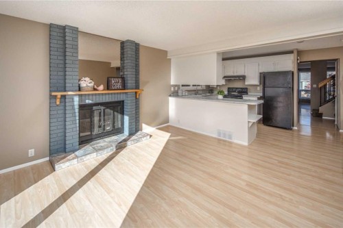 27 Strathearn Crescent Sw, Calgary, AB - Indoor Photo Showing Other Room With Fireplace