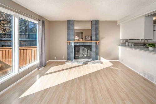 27 Strathearn Crescent Sw, Calgary, AB - Indoor Photo Showing Living Room With Fireplace