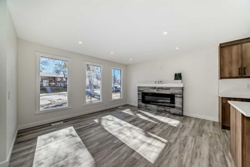 946 Berkley Drive Nw, Calgary, AB - Indoor Photo Showing Living Room With Fireplace