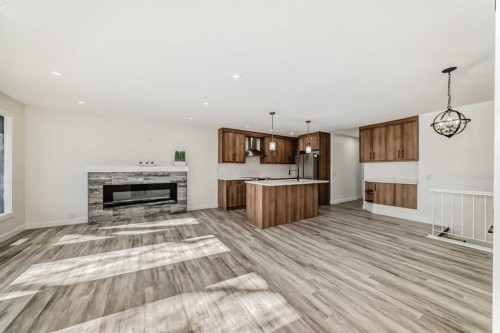946 Berkley Drive Nw, Calgary, AB - Indoor Photo Showing Living Room With Fireplace