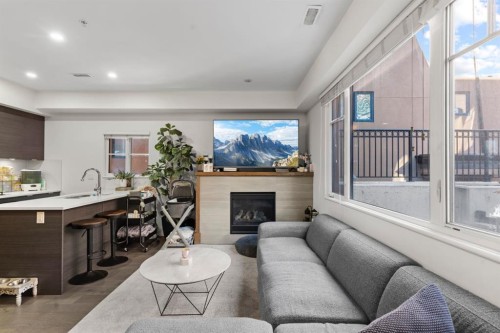 101-1818 14A Street Sw, Calgary, AB - Indoor Photo Showing Living Room With Fireplace