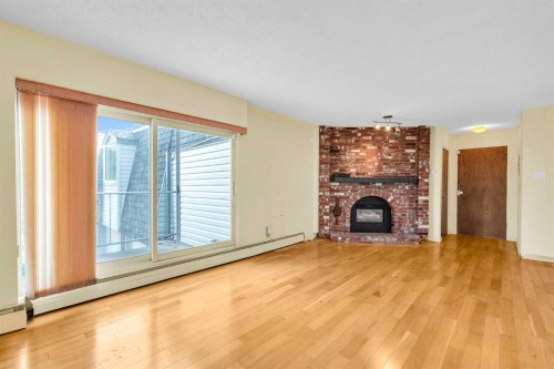 301-508 Cedar Crescent Sw, Calgary, AB - Indoor Photo Showing Living Room With Fireplace