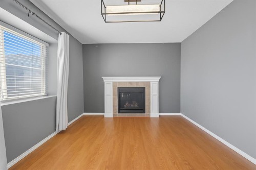 824 Luxstone Square Sw, Airdrie, AB - Indoor With Fireplace