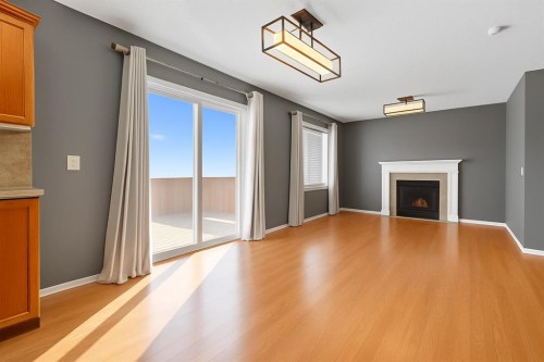 824 Luxstone Square Sw, Airdrie, AB - Indoor Photo Showing Living Room With Fireplace