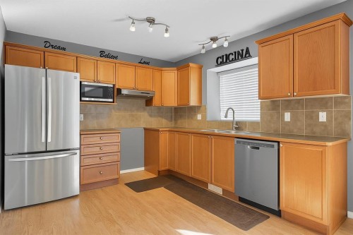 824 Luxstone Square Sw, Airdrie, AB - Indoor Photo Showing Kitchen With Double Sink