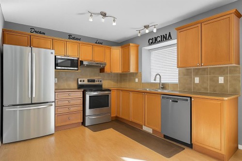 824 Luxstone Square Sw, Airdrie, AB - Indoor Photo Showing Kitchen With Double Sink