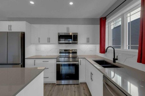 827 Windbury Street Sw, Airdrie, AB - Indoor Photo Showing Kitchen With Double Sink