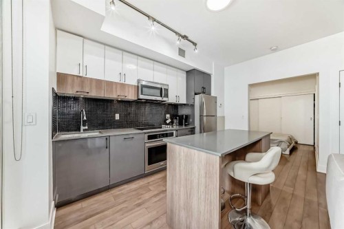 423-619 Confluence Way Se, Calgary, AB - Indoor Photo Showing Kitchen With Upgraded Kitchen