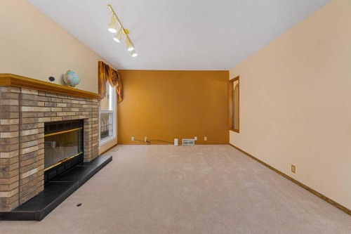 91 Coral Springs Boulevard Ne, Calgary, AB - Indoor Photo Showing Other Room With Fireplace