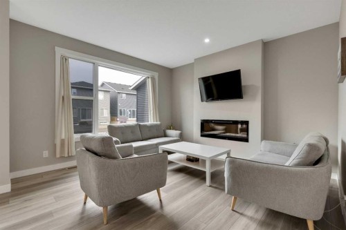 216 Creekstone Row Sw, Calgary, AB - Indoor Photo Showing Living Room With Fireplace