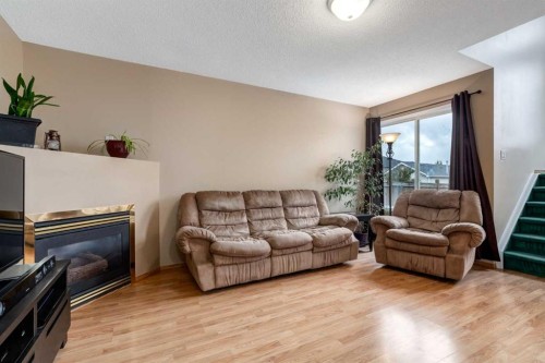 168 Mt Apex Green Se, Calgary, AB - Indoor Photo Showing Living Room With Fireplace