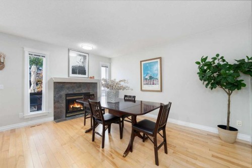 339 Bridlewood Court Sw, Calgary, AB - Indoor Photo Showing Dining Room With Fireplace