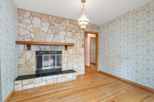 100 Fairview Drive Se, Calgary, AB - Indoor With Fireplace