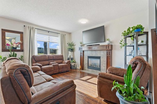106 Copperstone Close Se, Calgary, AB - Indoor Photo Showing Living Room With Fireplace