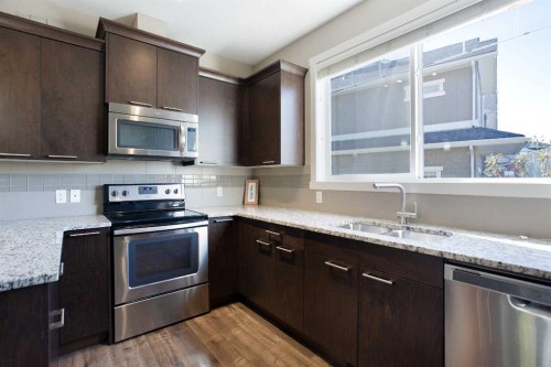 107 Evanston Manor Nw, Calgary, AB - Indoor Photo Showing Kitchen With Double Sink