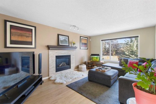 38 Spring Crescent Sw, Calgary, AB - Indoor Photo Showing Living Room With Fireplace