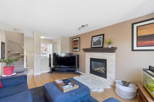 38 Spring Crescent Sw, Calgary, AB - Indoor Photo Showing Living Room With Fireplace