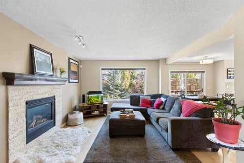38 Spring Crescent Sw, Calgary, AB - Indoor Photo Showing Living Room With Fireplace