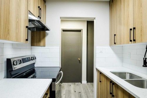 1121 37 Street Sw, Calgary, AB - Indoor Photo Showing Kitchen With Double Sink