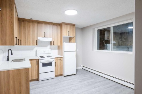 1121 37 Street Sw, Calgary, AB - Indoor Photo Showing Kitchen With Double Sink