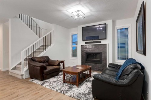 108 Harmony Circle, Rural Rocky View County, AB - Indoor Photo Showing Living Room With Fireplace