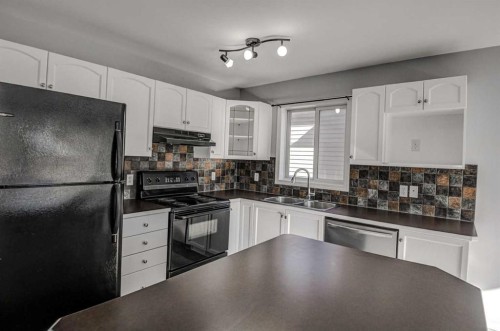 61 Everstone Avenue Sw, Calgary, AB - Indoor Photo Showing Kitchen With Double Sink