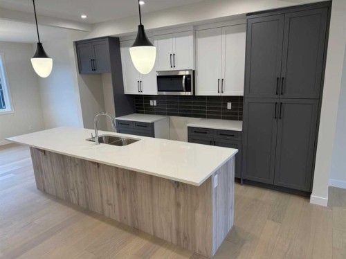 334 Sundown Road, Cochrane, AB - Indoor Photo Showing Kitchen With Double Sink With Upgraded Kitchen