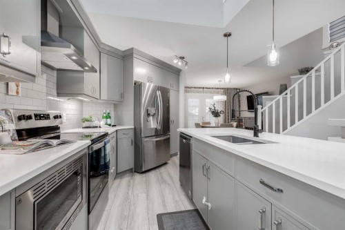 1037 Chinook Gate Heath Sw, Airdrie, AB - Indoor Photo Showing Kitchen With Stainless Steel Kitchen With Double Sink With Upgraded Kitchen