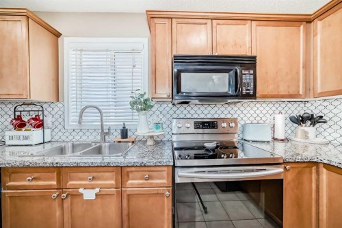 423 Morningside Way Sw, Airdrie, AB - Indoor Photo Showing Kitchen With Double Sink