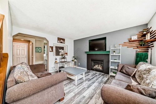 423 Morningside Way Sw, Airdrie, AB - Indoor Photo Showing Living Room With Fireplace