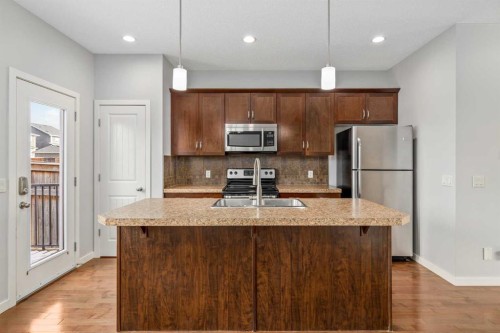 84 Fireside Way, Cochrane, AB - Indoor Photo Showing Kitchen With Double Sink