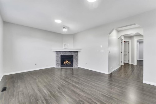 11 Saddlebrook Way Ne, Calgary, AB - Indoor Photo Showing Living Room With Fireplace