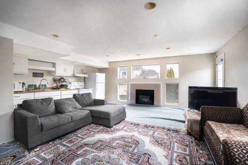 8051 Laguna Way Ne, Calgary, AB - Indoor Photo Showing Living Room With Fireplace