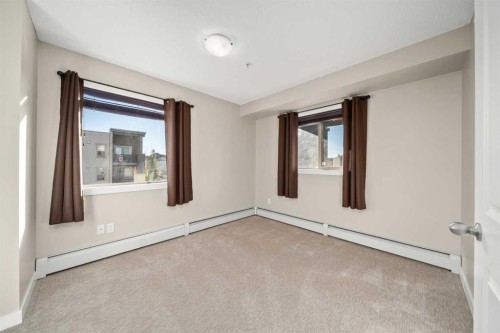 3309-403 Mackenzie Way Sw, Airdrie, AB - Indoor Photo Showing Other Room