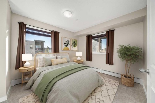 3309-403 Mackenzie Way Sw, Airdrie, AB - Indoor Photo Showing Bedroom