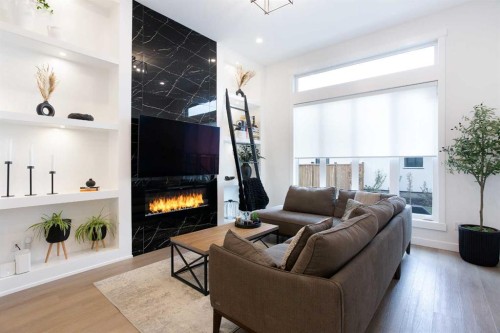 4628 15 Avenue Nw, Calgary, AB - Indoor Photo Showing Living Room With Fireplace
