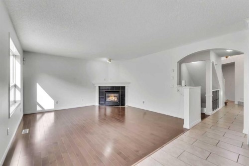 338 Panamount Drive Nw, Calgary, AB - Indoor Photo Showing Living Room With Fireplace