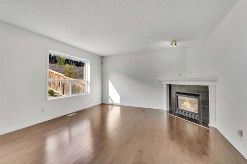 338 Panamount Drive Nw, Calgary, AB - Indoor Photo Showing Living Room With Fireplace