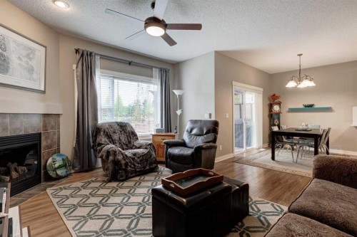 267 Silverado Plains Close Sw, Calgary, AB - Indoor Photo Showing Living Room With Fireplace
