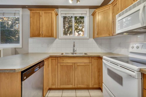 106-2411 Erlton Road Sw, Calgary, AB - Indoor Photo Showing Kitchen With Double Sink