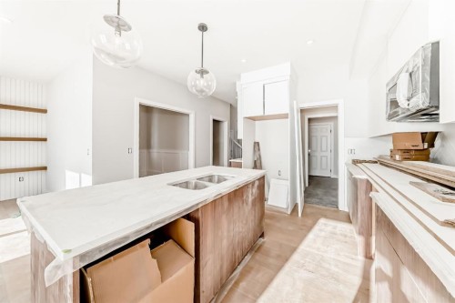 512 Heritage Boulevard, Cochrane, AB - Indoor Photo Showing Kitchen With Double Sink